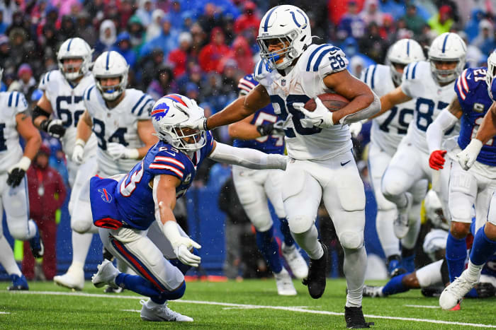 Nov 21, 2021; Orchard Park, New York, USA; Indianapolis Colts running back Jonathan Taylor (28) stiff-arms Buffalo Bills safety Micah Hyde (23) on a run during the second half at Highmark Stadium. Mandatory Credit: Rich Barnes-USA TODAY Sports